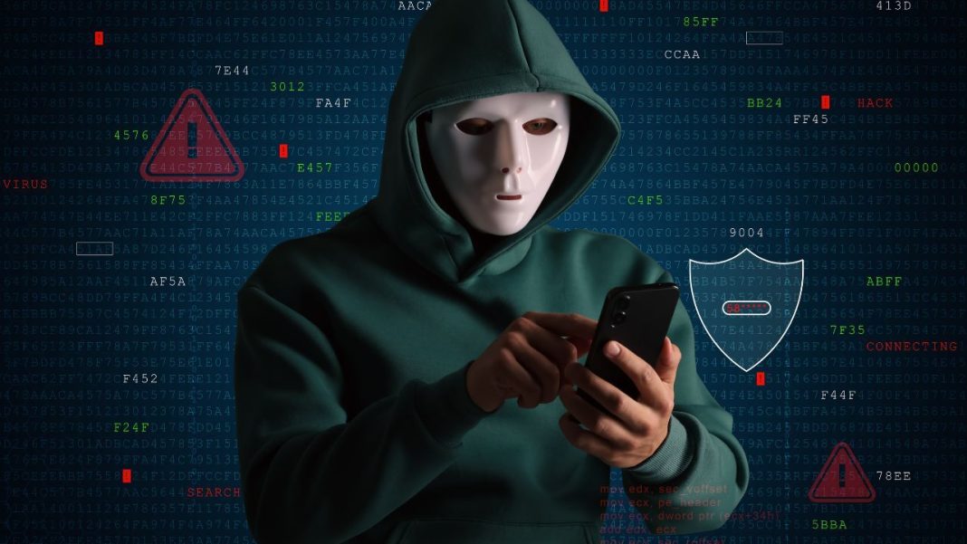 Krypto podvody na Instagramu, anonymní postava v kapuci u notebooku jako symbol skrytého podvodníka