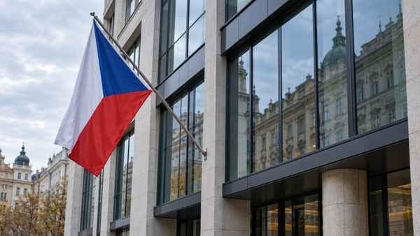 Moderní finanční budova s českou vlajkou